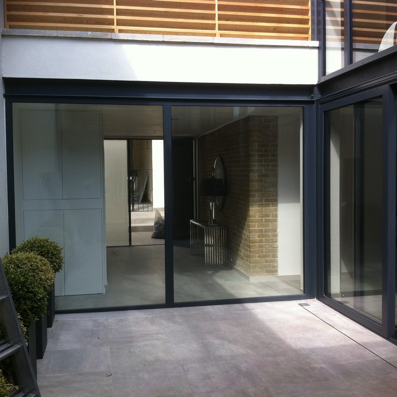 Floor-to-ceiling sliding doors opening to courtyard in Highgate