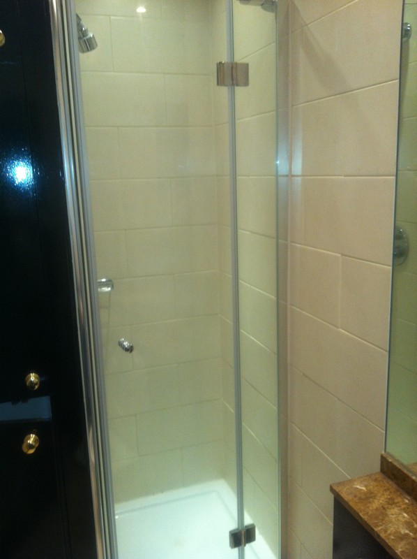 Frameless glass shower enclosure with chrome fittings in Highgate