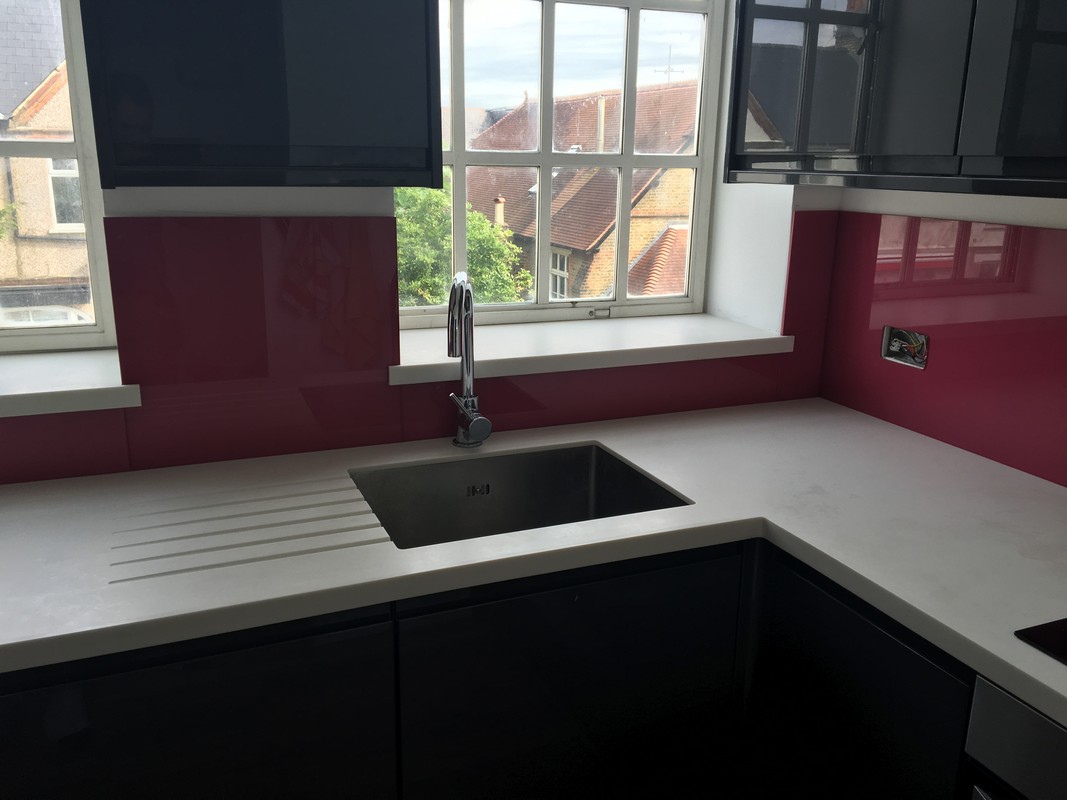 Deep plum coloured glass splashback in modern Highgate kitchen
