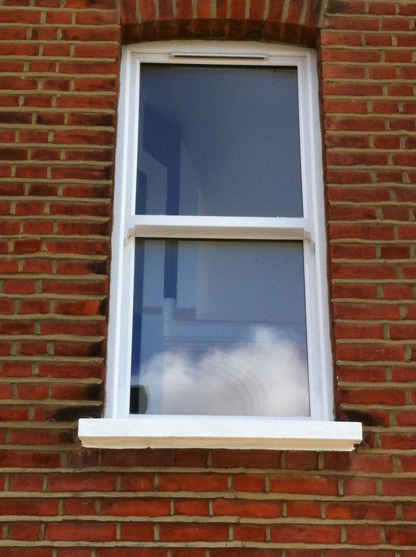 uPVC sash window on Victorian red brick house in Highgate